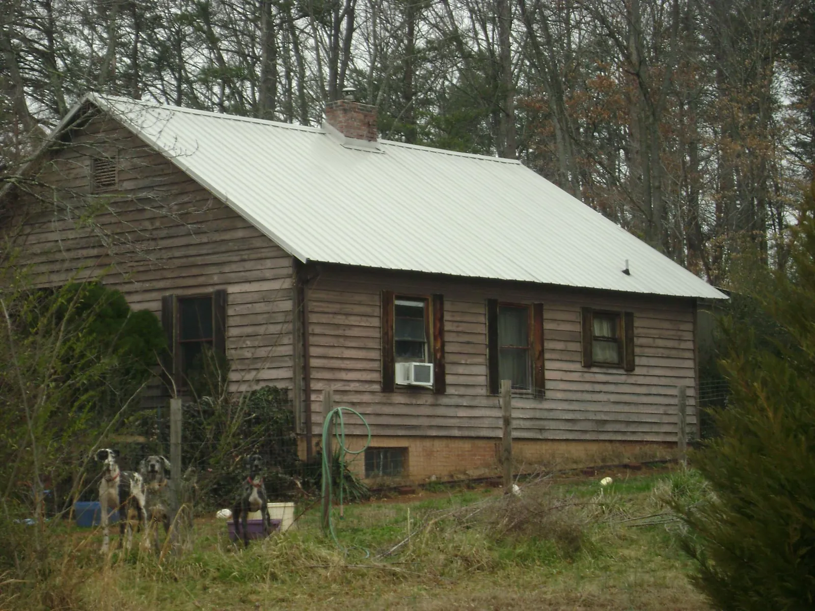 White metal roof on an old wood sided farmhouse, from a Metal Roof Installation job in La Crescent